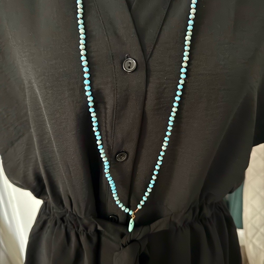 This is like new black top with a tie waist and buttons. - Picture 3 of 4